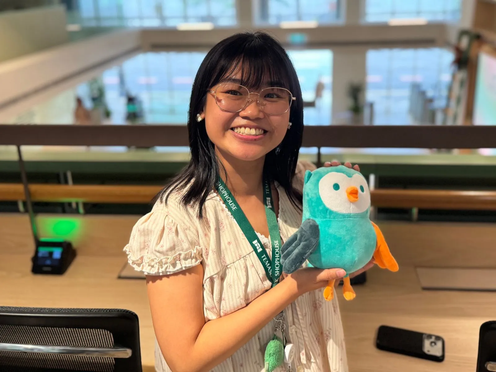 Sandy Kee holding a plush stuffed animal.
