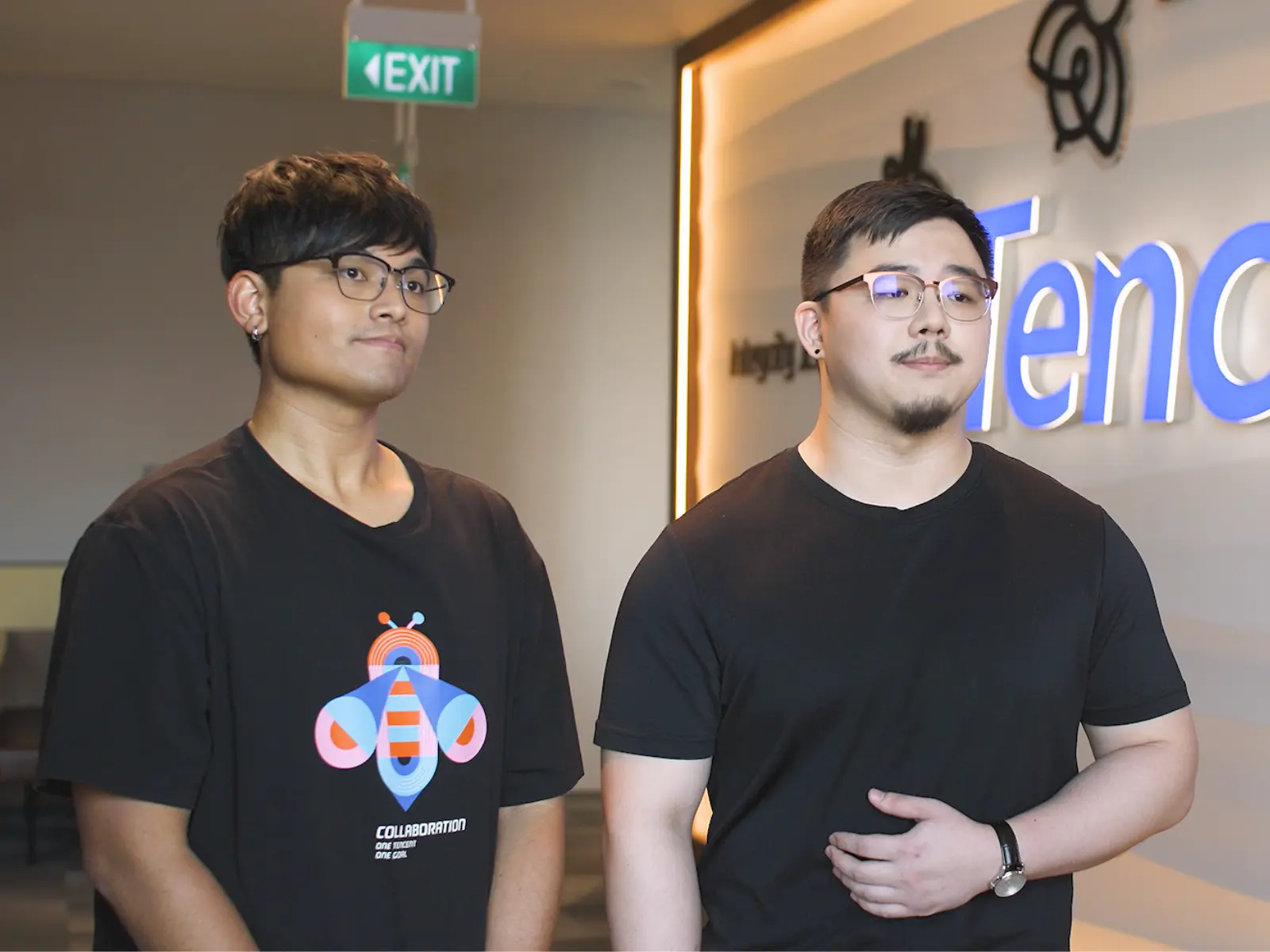 Alumni Gordon Christian and Hoo Xin Jie stand together in front of a Tencent logo.