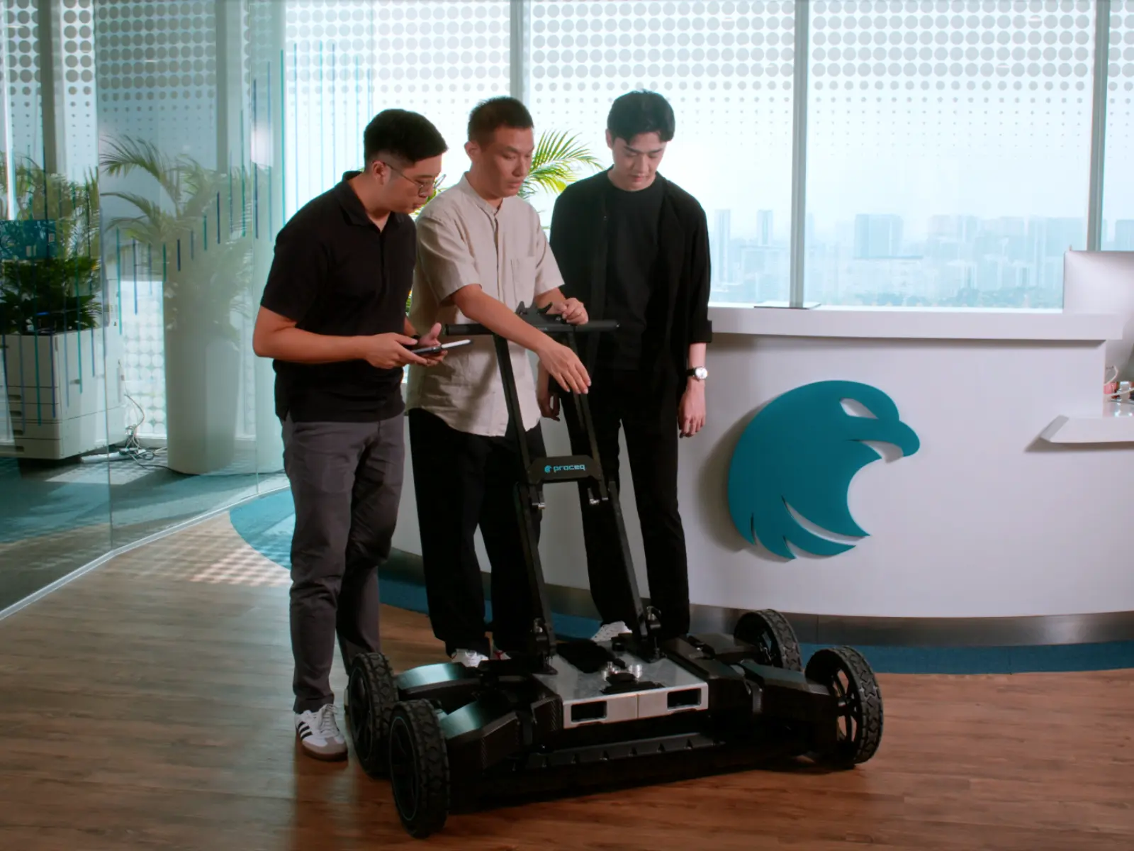 A group of men stand around a large robot with wheels.